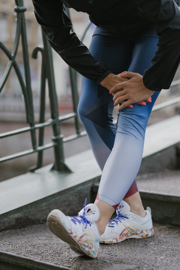 Person in sportswear stretching on outdoor steps, promoting fitness and wellness.